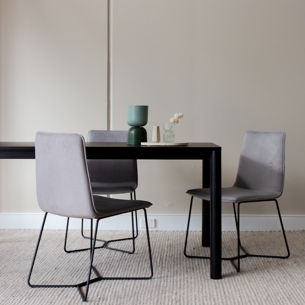 Three minimalist gray dining chairs